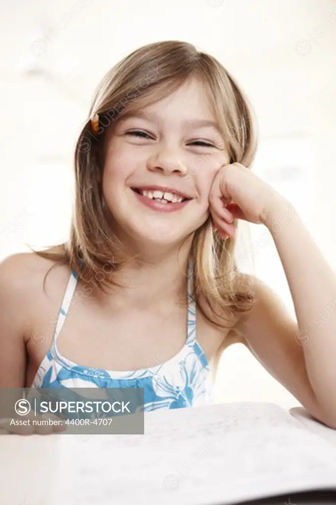 Girl leaning on table, smiling