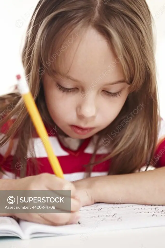 Girl writing on notebook