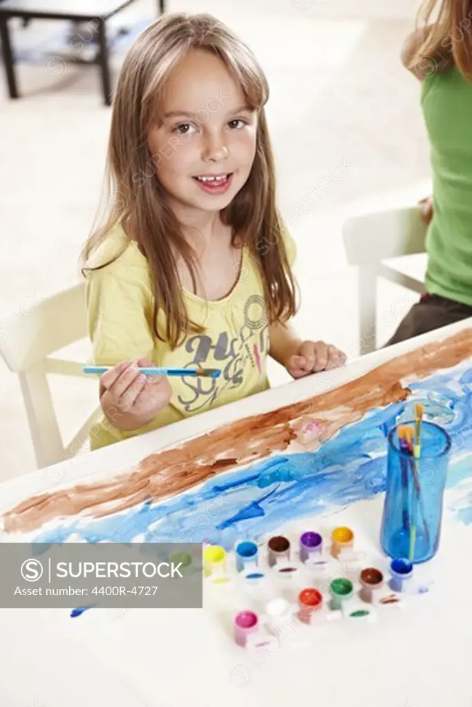 Girl painting with watercolour paints