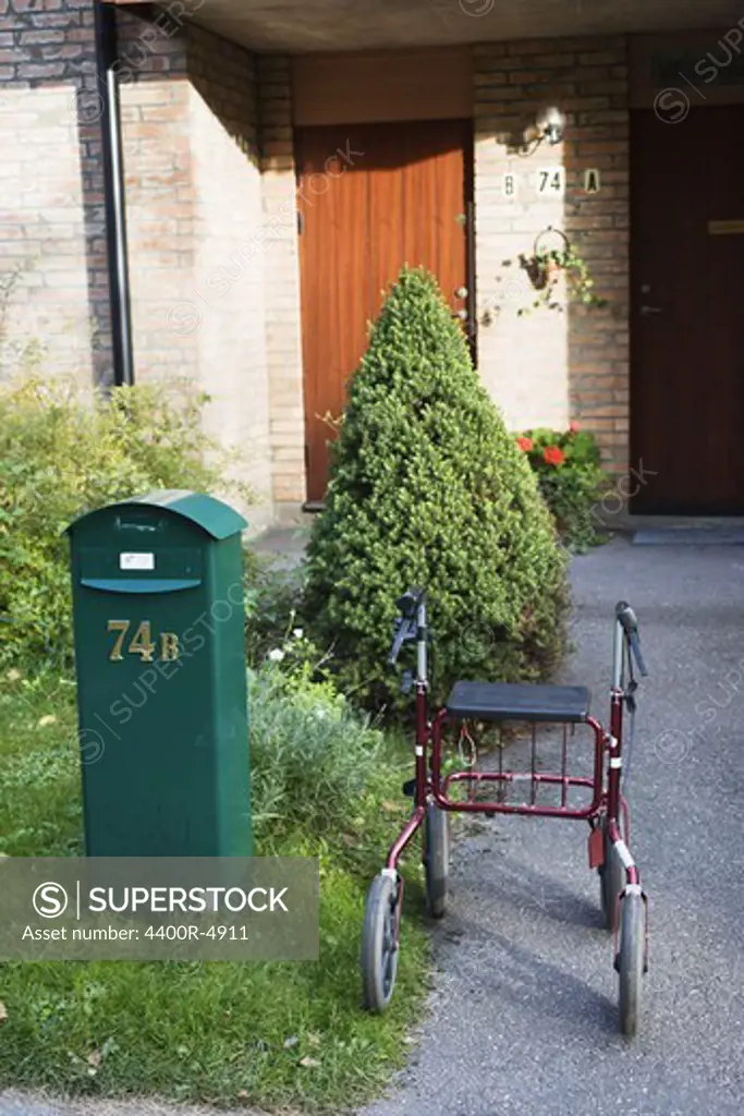 Letterbox and pushchair on courtyard