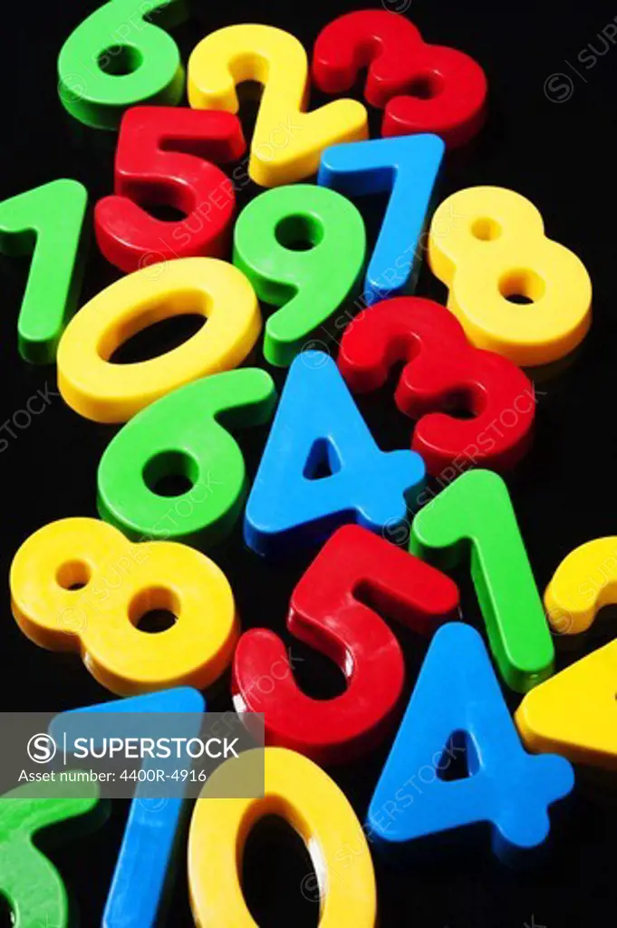 Toy numbers on black background, close-up