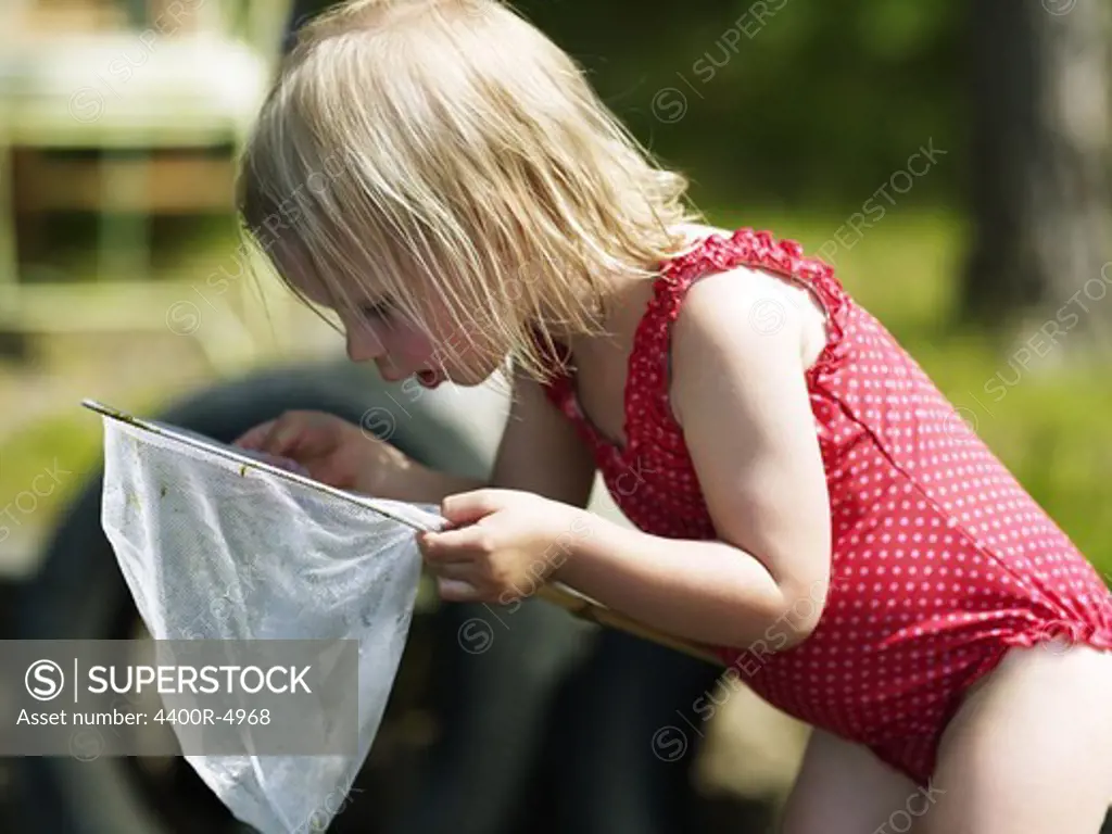 Girl looking into butterfly net