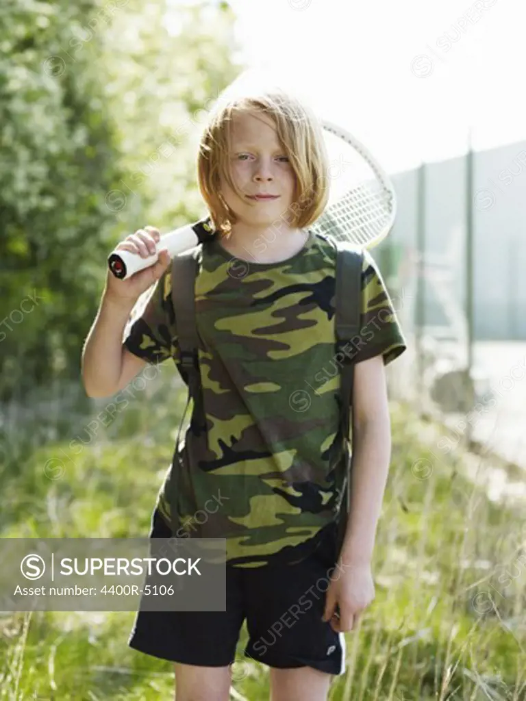 Portrait of boy holding tennis racket