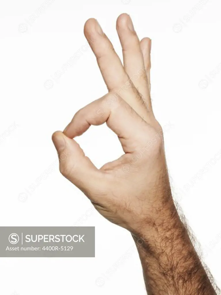 Man making sign with hand against white background
