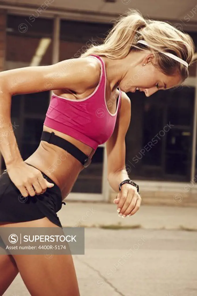 Female runner checking time on wristwatch