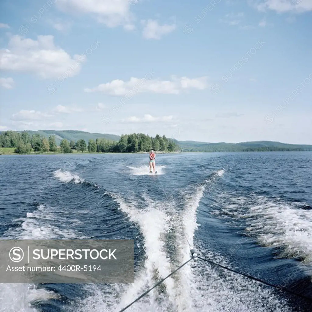 Person waterskiing on lake