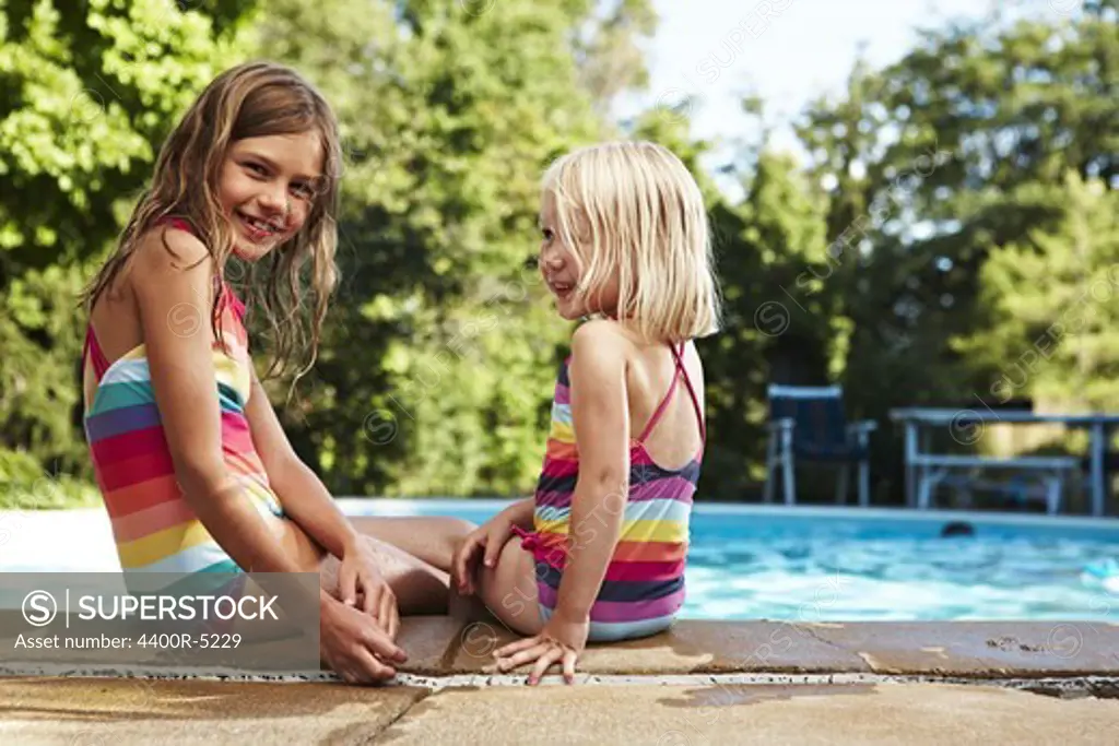 Portrait of two girls at poolside
