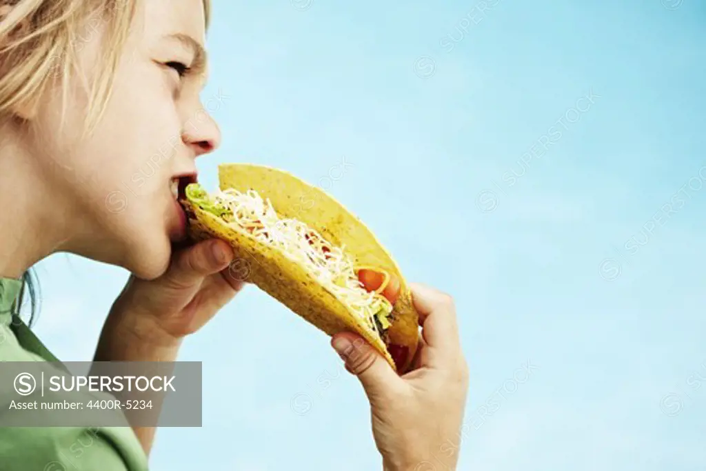 Boy eating taco