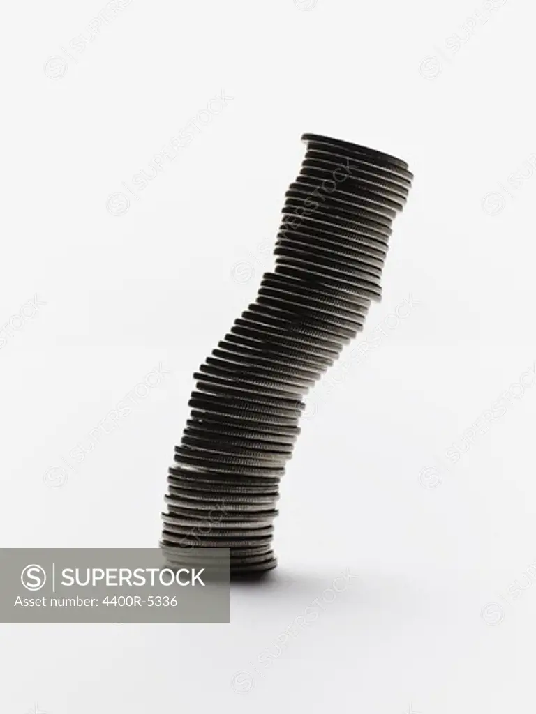 Close up of coin stack  falling on white background