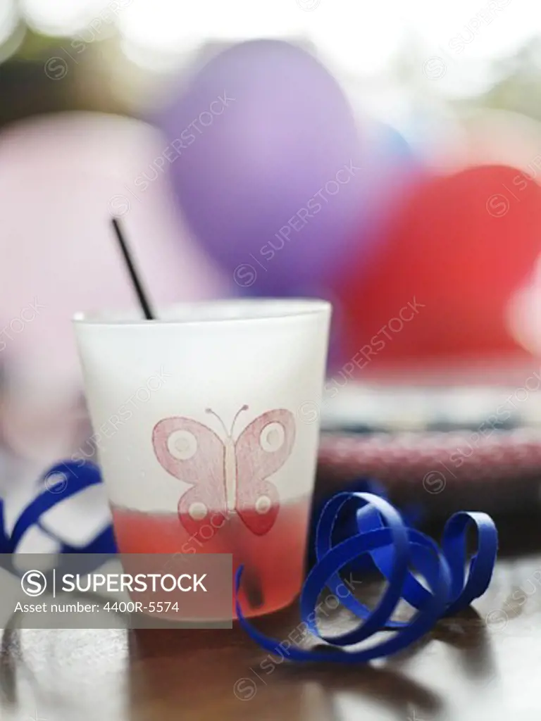 A fruit drink with a straw at a party, Sweden.