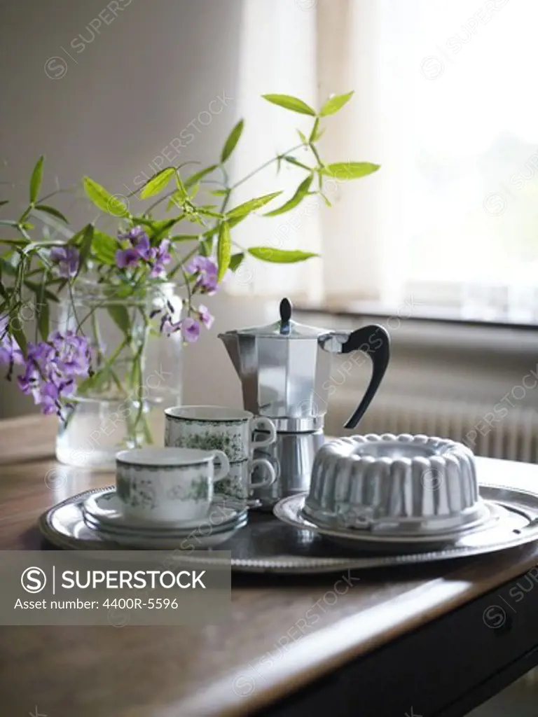 A tray with coffee cups and a sponge cake, Sweden.