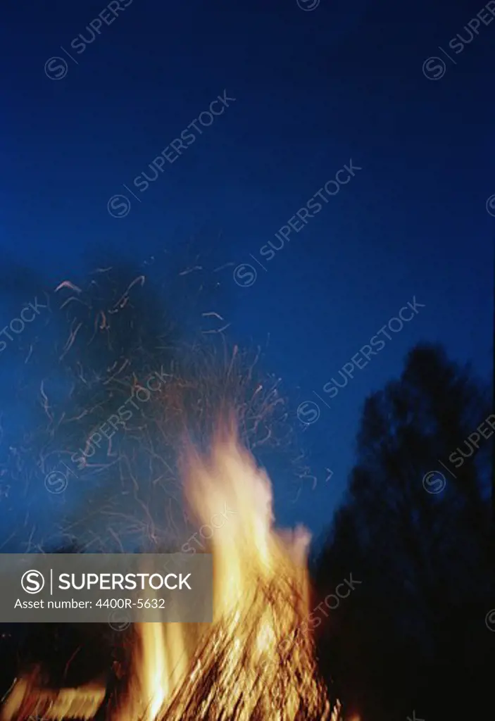 A bonfire against a blue dark sky, Sweden.