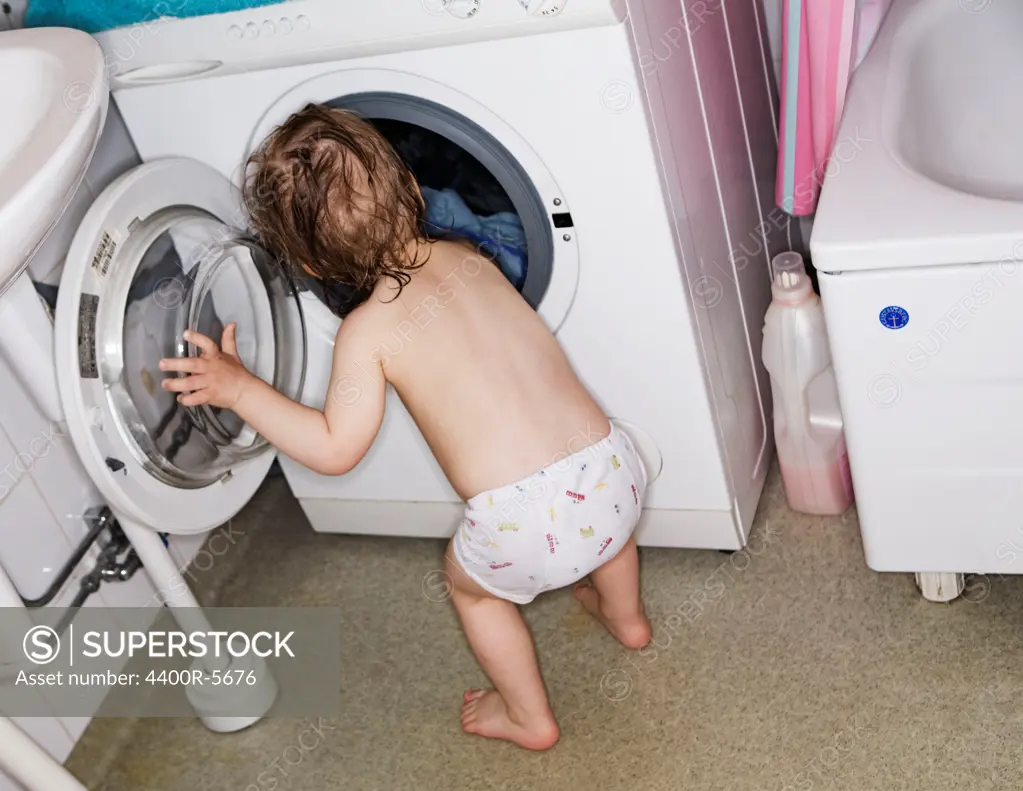 Boy doing laundry, Sweden.