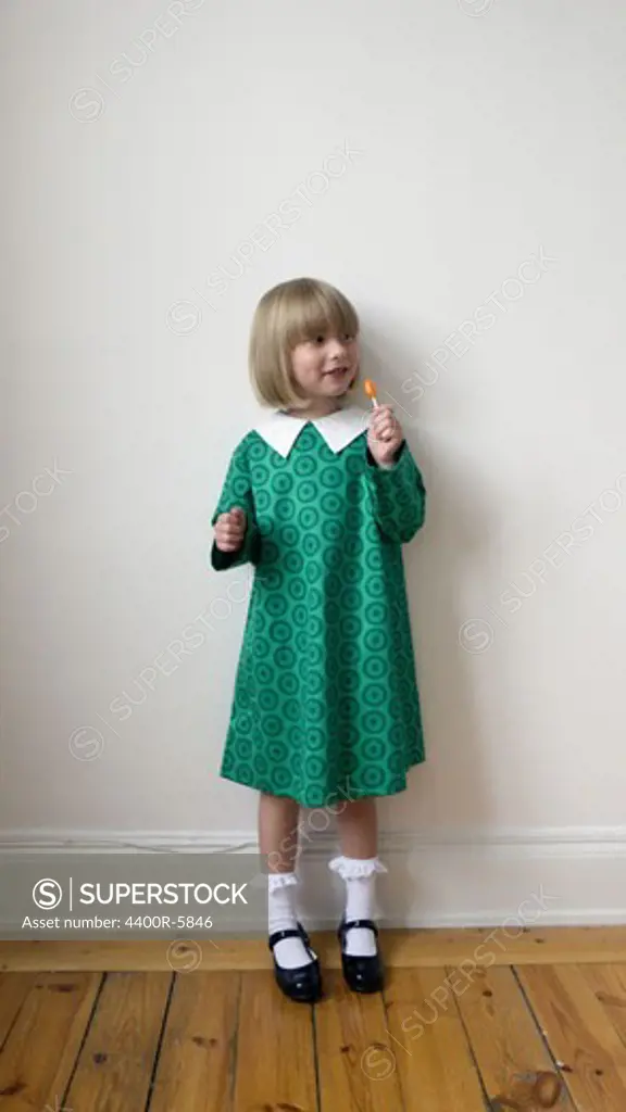 Portrait of a girl holding a lollipop, Sweden.