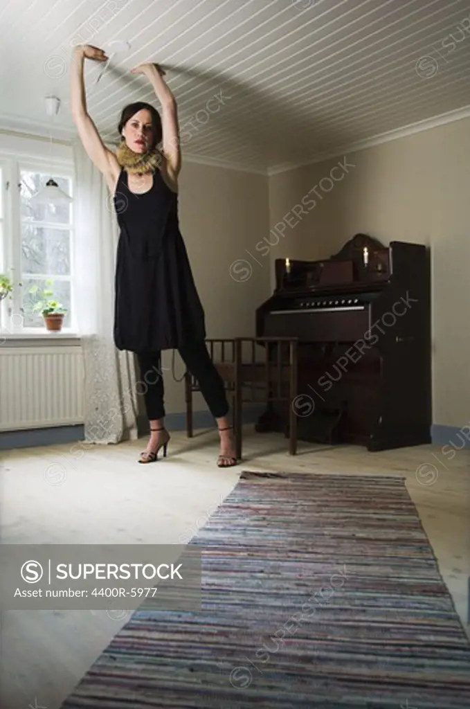 Woman in a room that is too small in dimensions, Sweden.