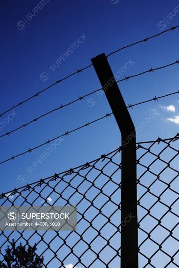 A fence with barb wire.