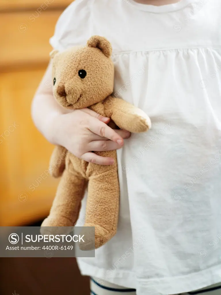 A girl holding a teddybear.