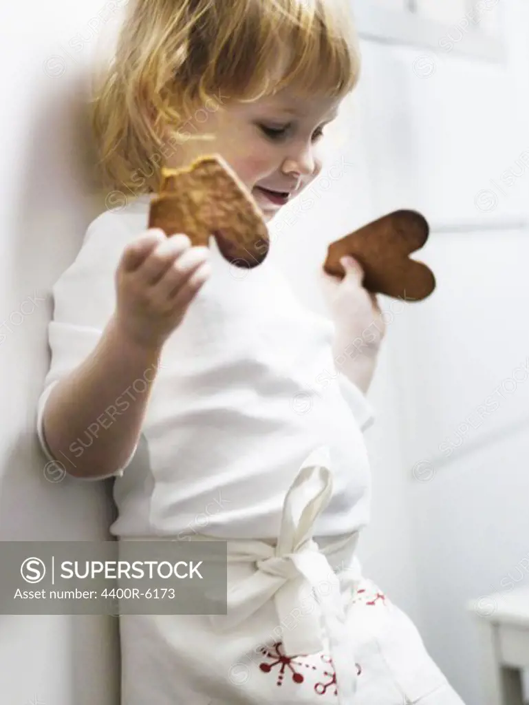 A little girl baking gingerbread, Sweden.