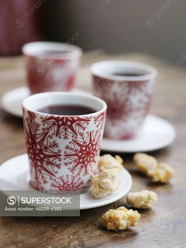 Three cups of mulled wine served with raisins and almonds, Sweden.
