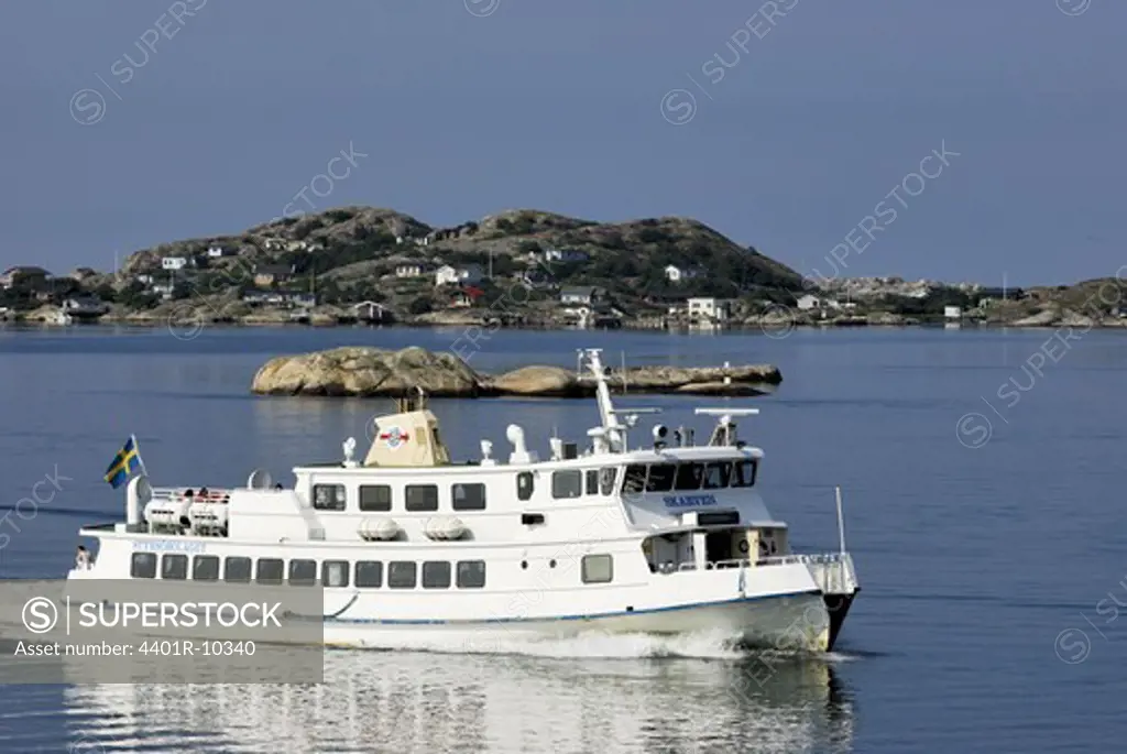A passenger steamer passing an island, Sweden.