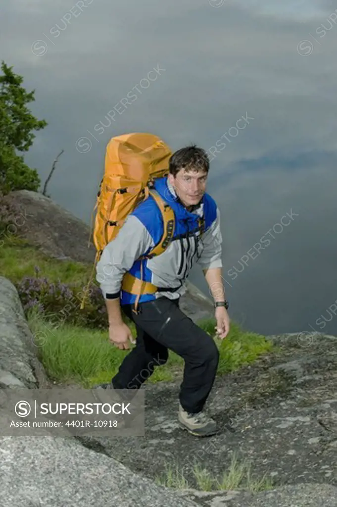 Portrait of a man hiking by a lake, Sweden.