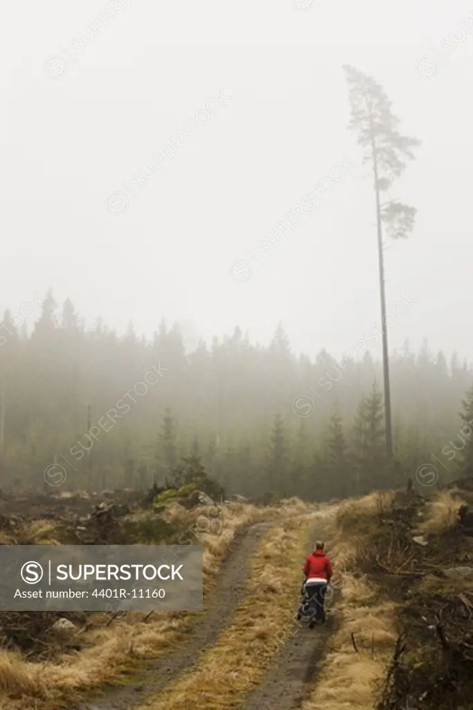 Scandinavian Peninsula, Sweden, Skåne, Småland, Woman walking on dirt track