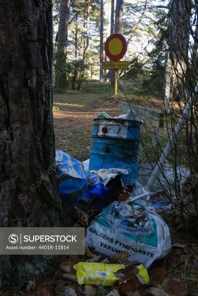 Scandinavia, Sweden, Oland, Rubbish and sign post in forest