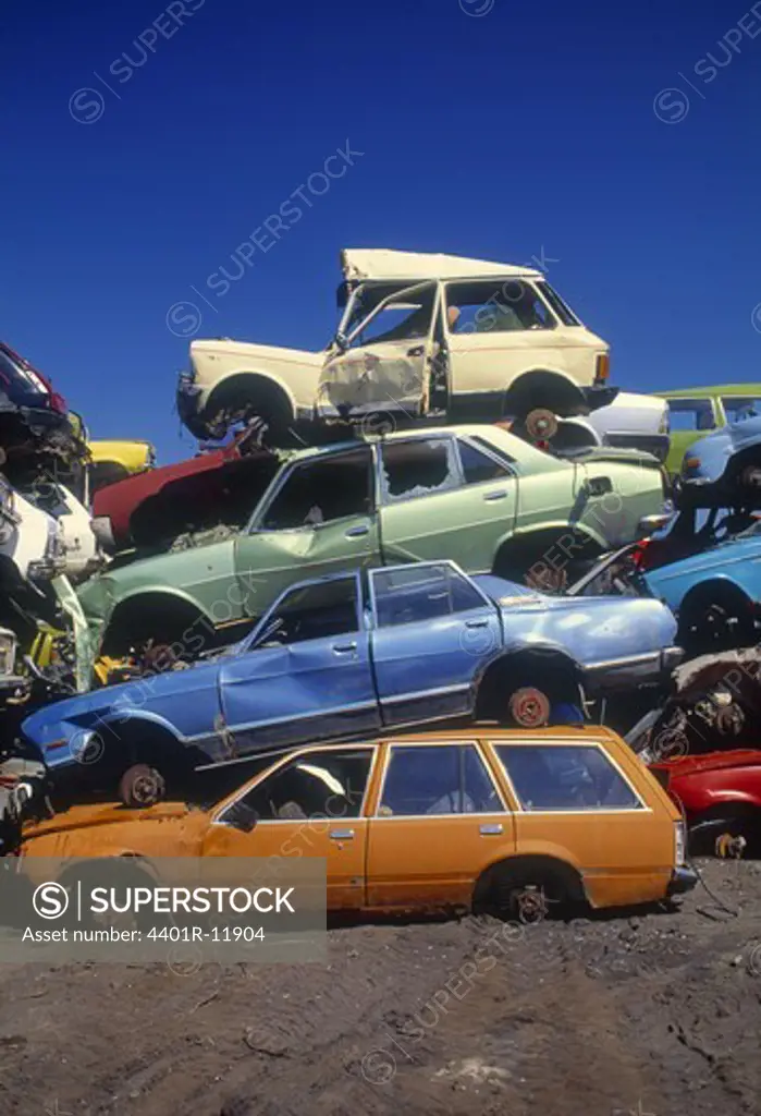 Stack of wrecked cars in junkyard