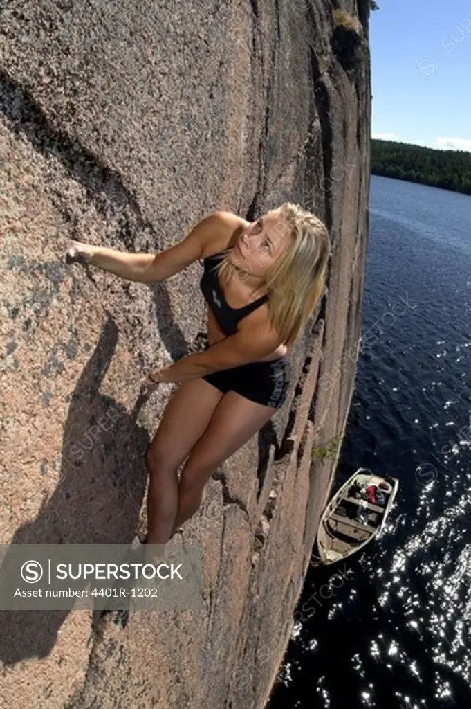 A woman rock climbing, Sweden.