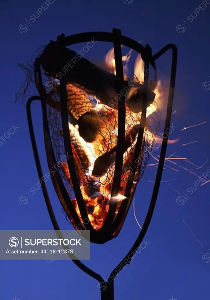 Burning fire basket at dusk