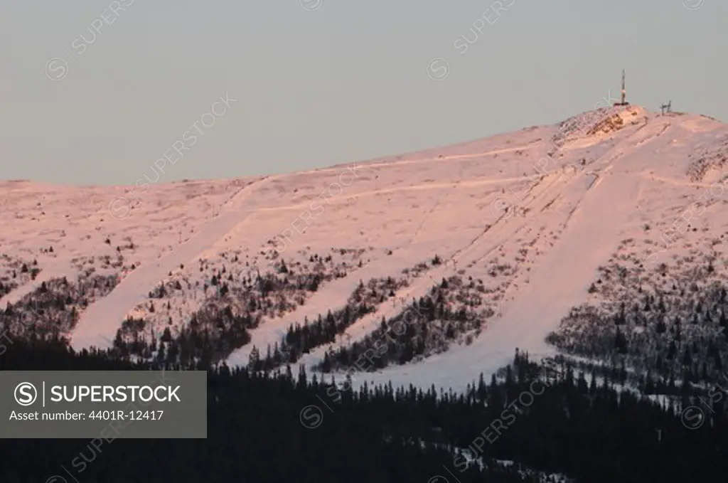 Scandinavia, Sweden, Harjedalen, View of snow covered mountain at dawn