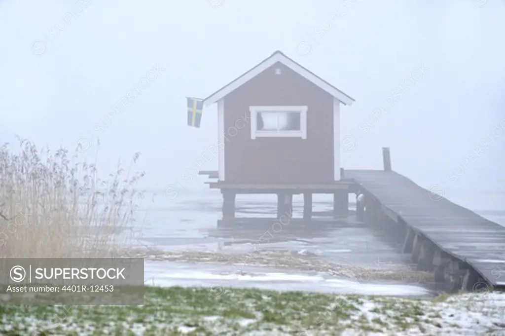 Pier and hut in fog