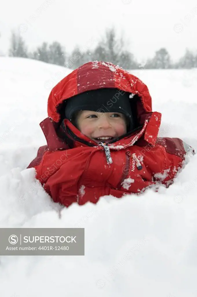 Boy being buried in snow