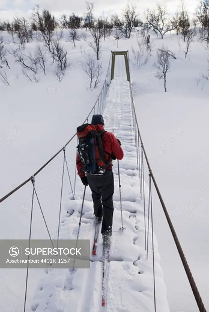 Skier on a footbridge, Sweden.