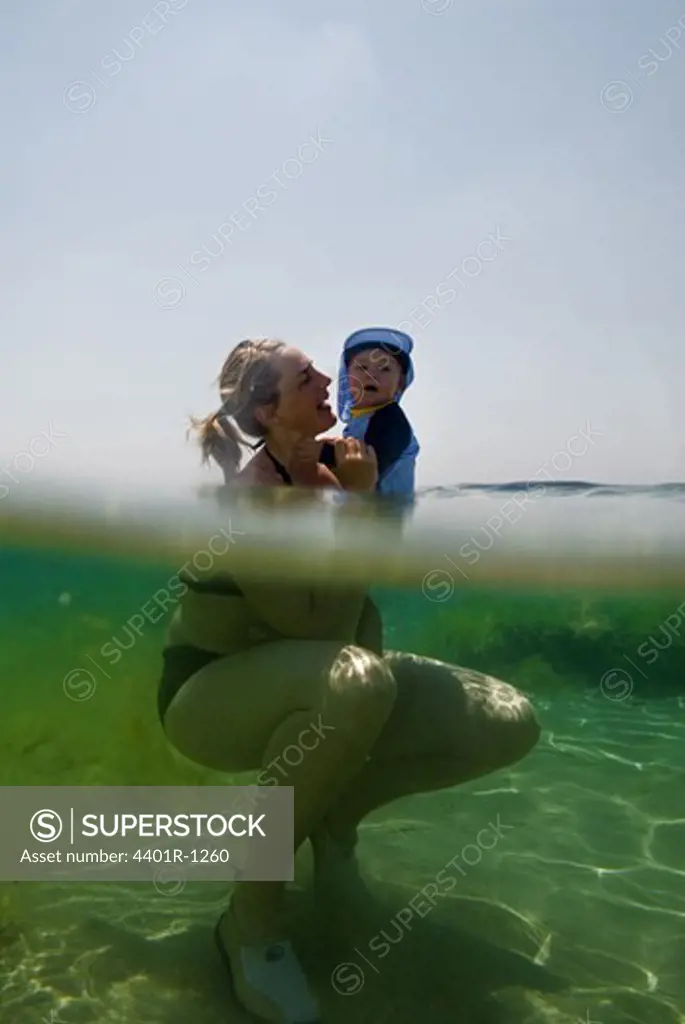 A Scandinavian mother and her child swimming, Greece.