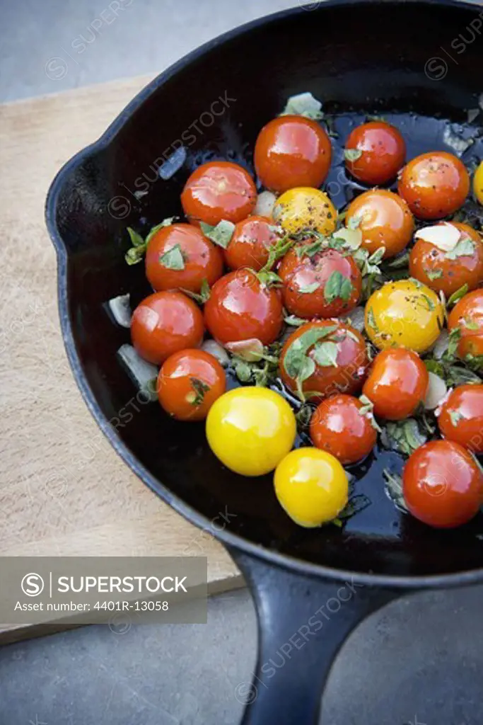 Cherry tomatoes cooking in pan