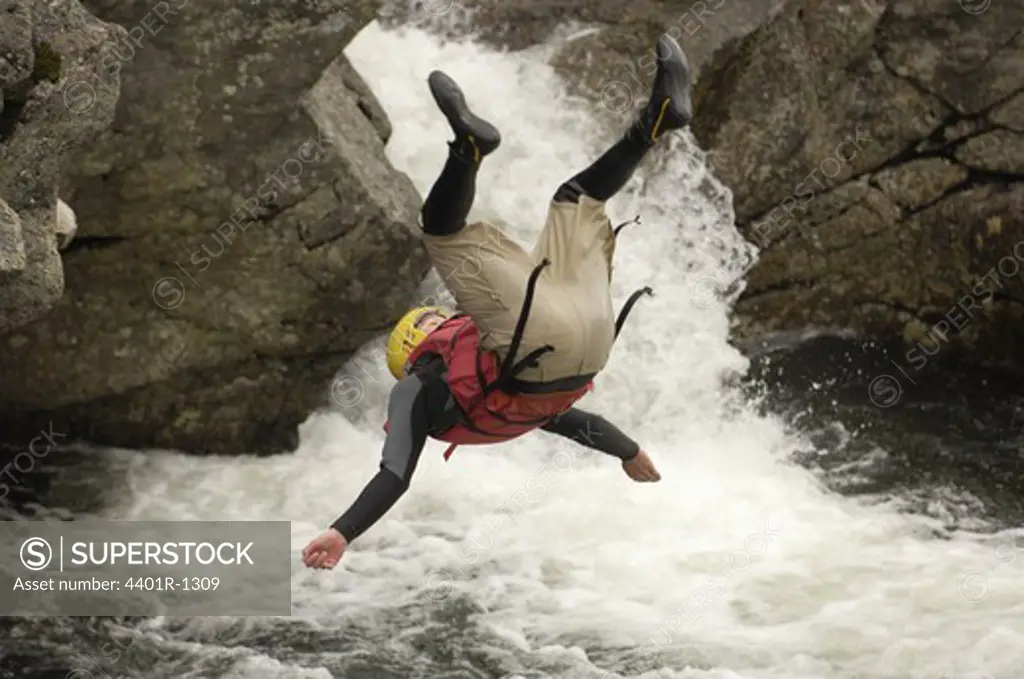A man jumping into the white water, Sweden.