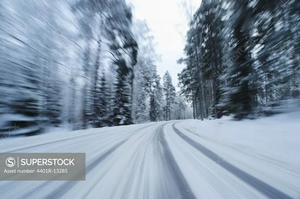 Blurred motion view of snow covered country road