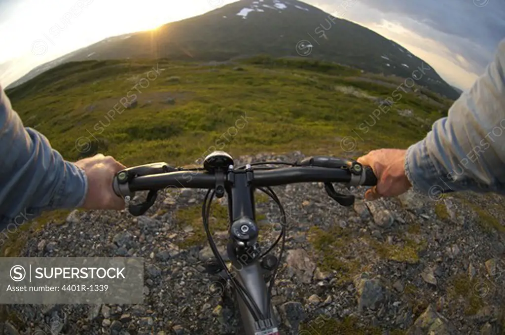 Ecotourist on mountainbike in Swedish mountains.