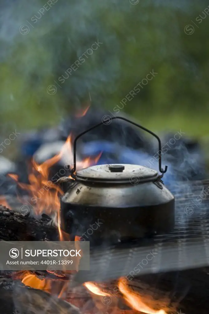 Coffee pot on burning logs