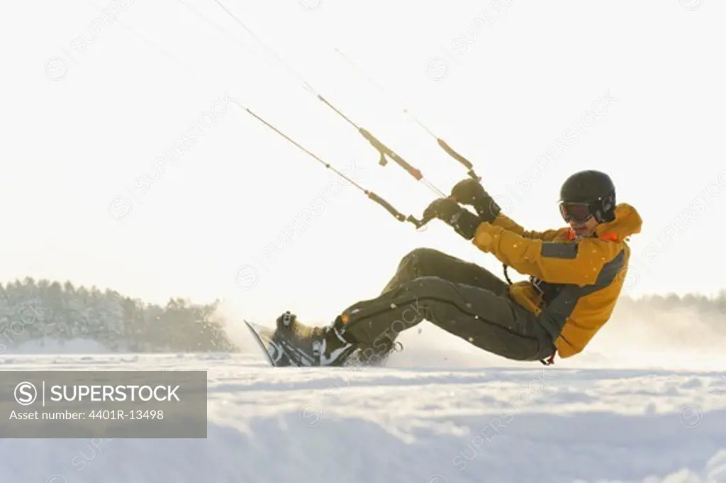 Man kiteboarding in snow