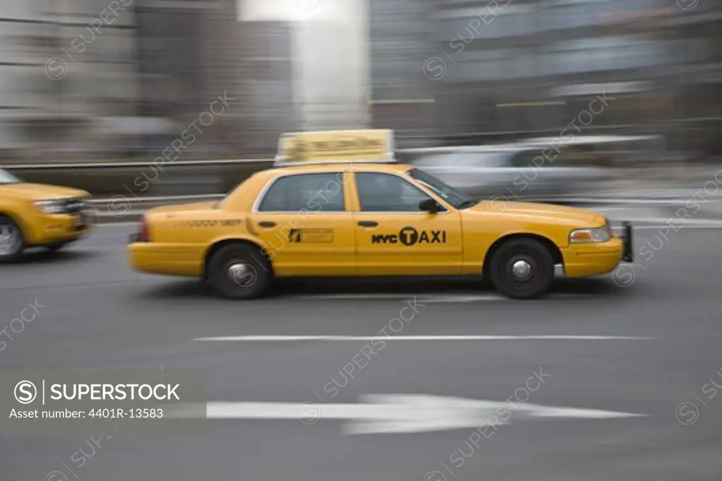 Yellow taxis on city street, blurred motion