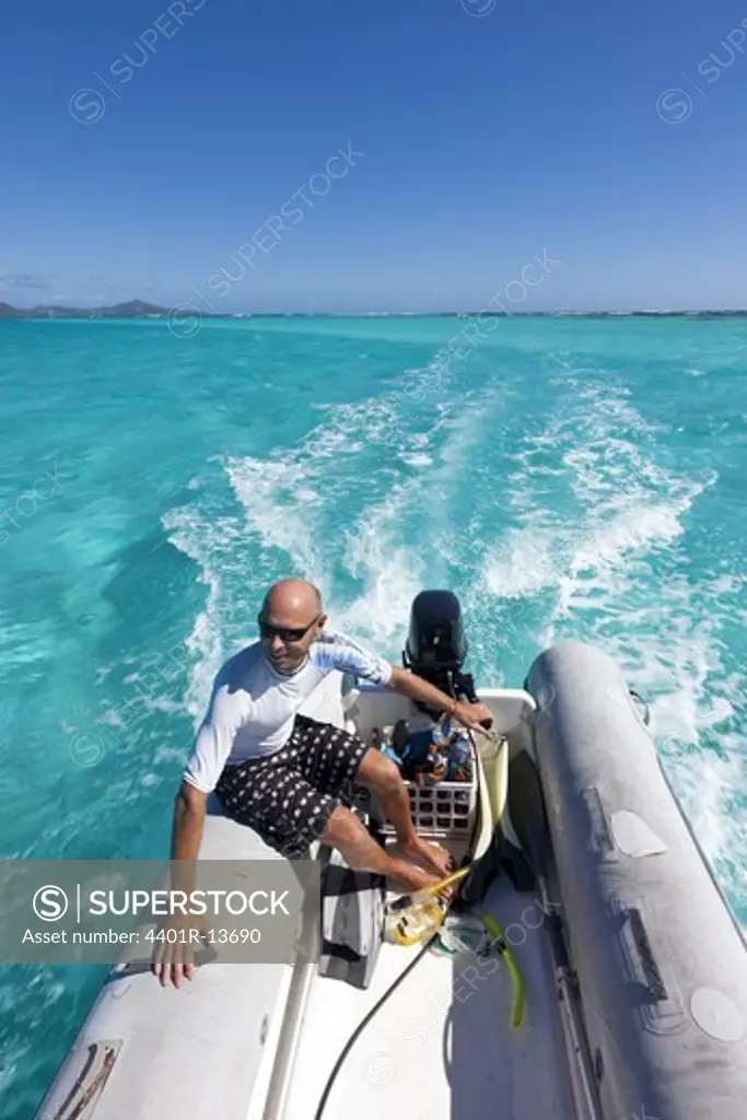 Man in dinghy on Caribbean Sea