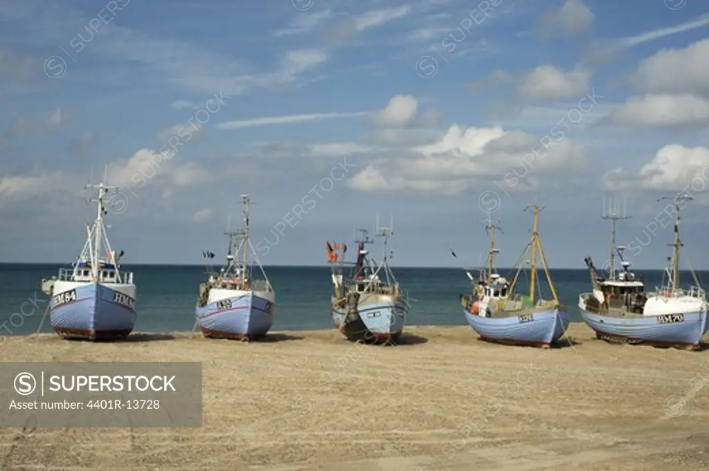 Row of fishing boats on sandy beach