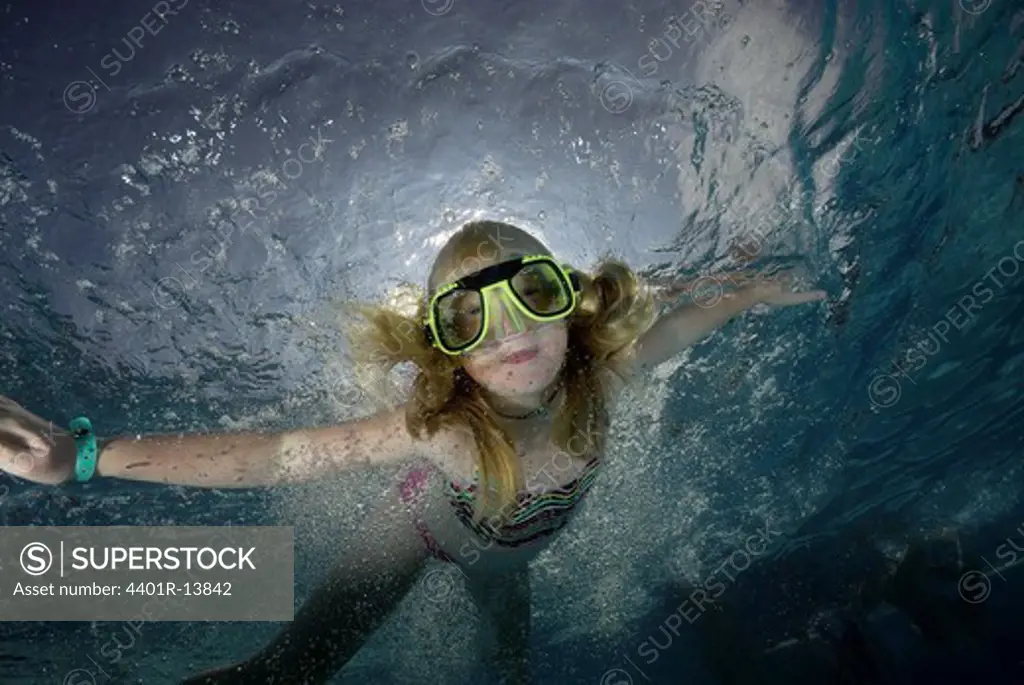 Girl diving under water