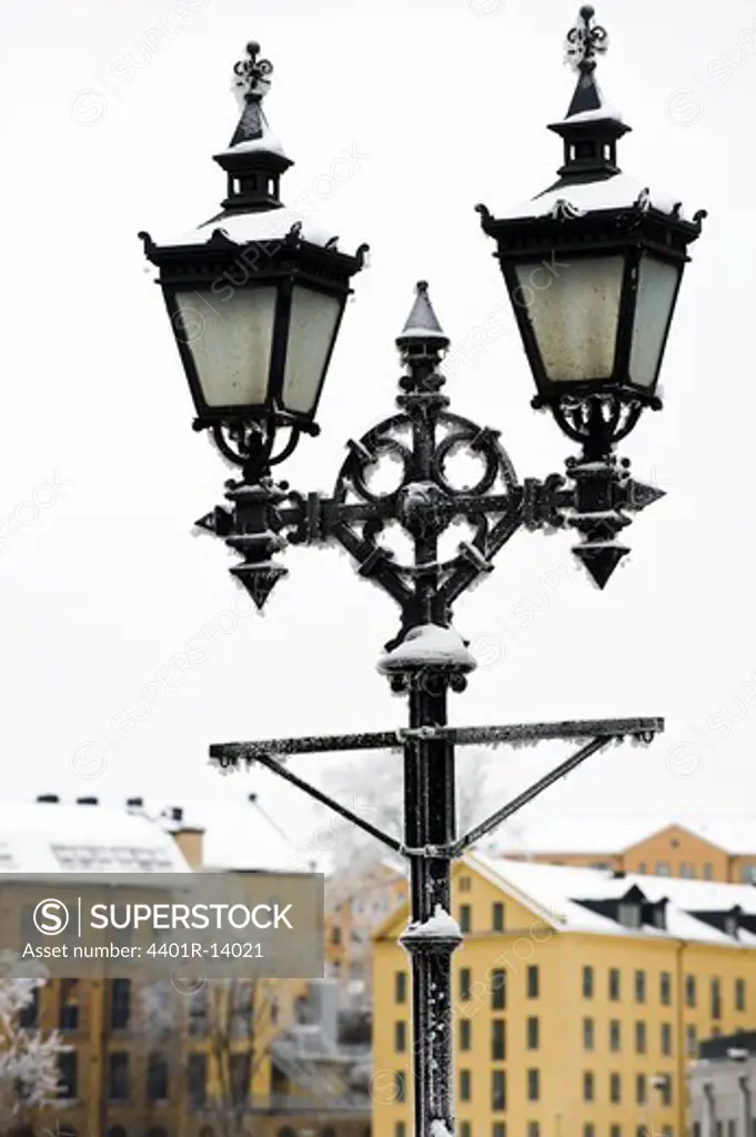 Snow-covered lamp post