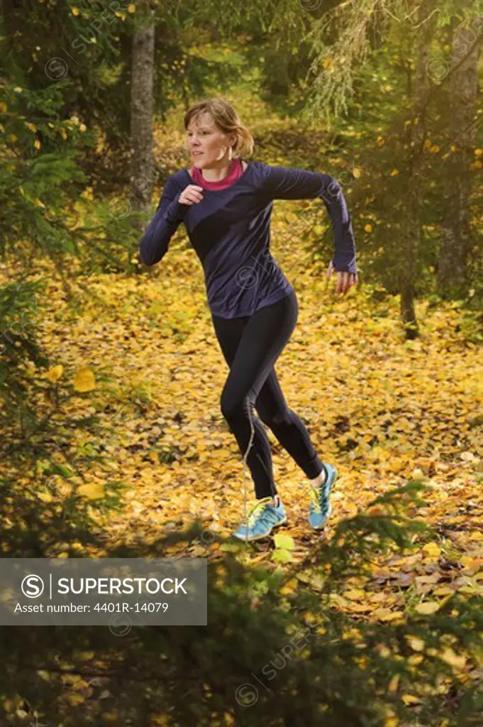 Young woman jogging in forest