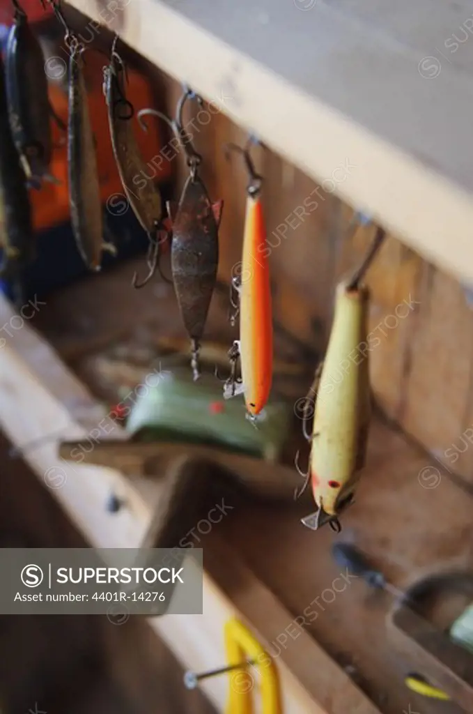 Fishing hooks hanging on shelf