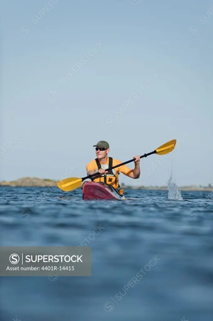 Man kayaking across sea, Sweden
