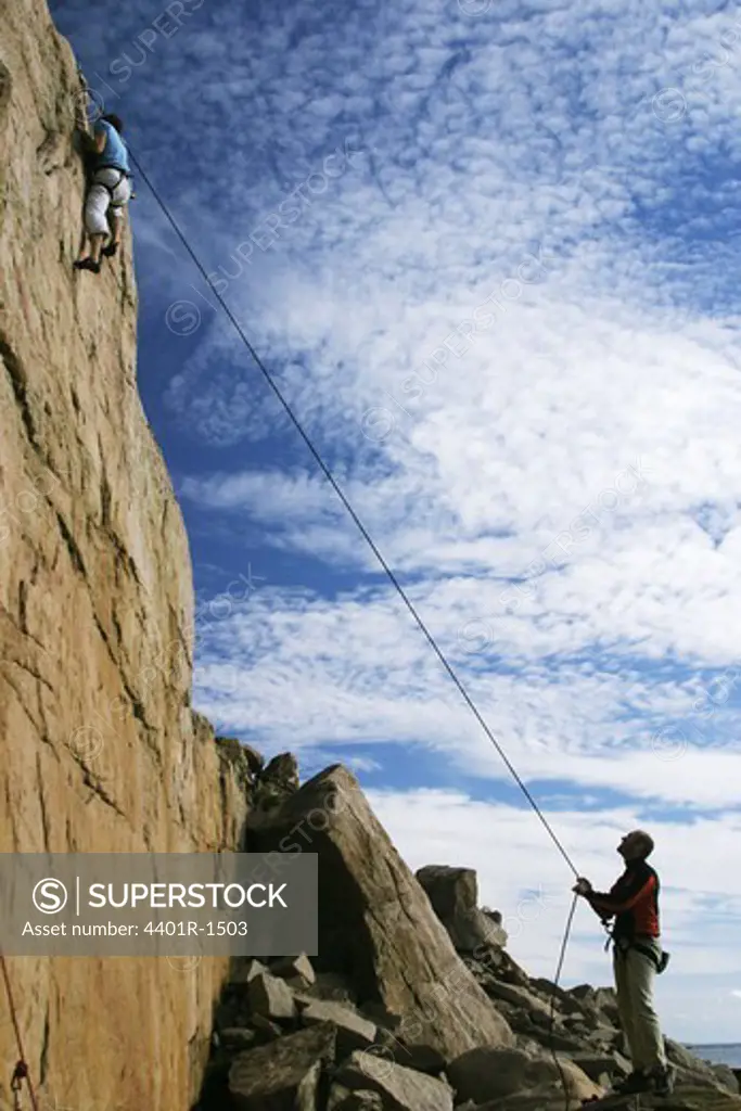 Two persons rock climbing, Sweden.